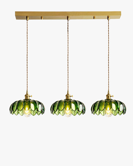 Three-shade pendant light with scalloped glass shades and brass-tone ceiling bar