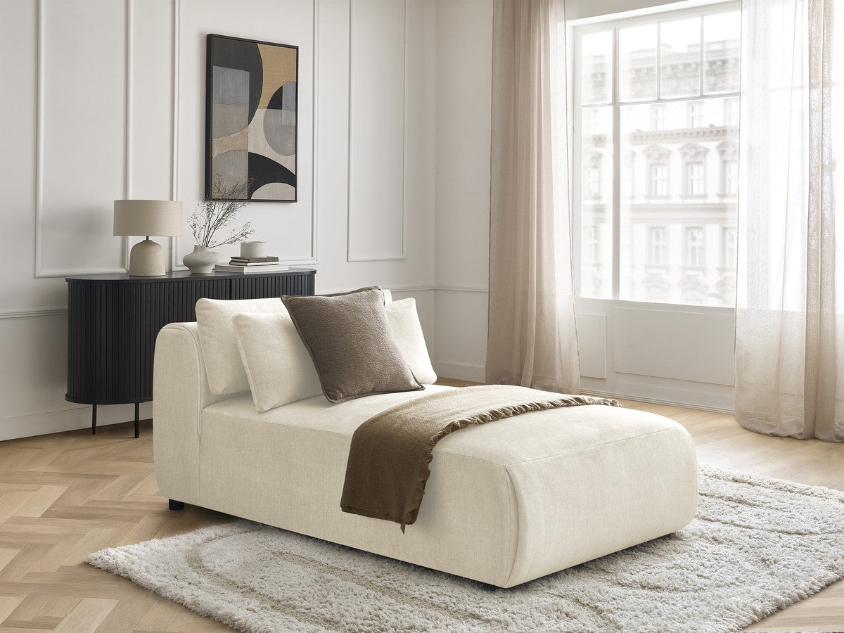 Modular chaise longue sofa section with raised headrest and velvet upholstery