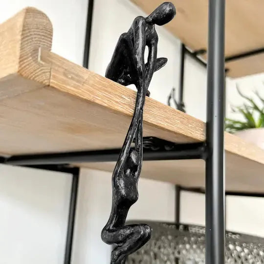 Black polystone figurine of two intertwined abstract human figures