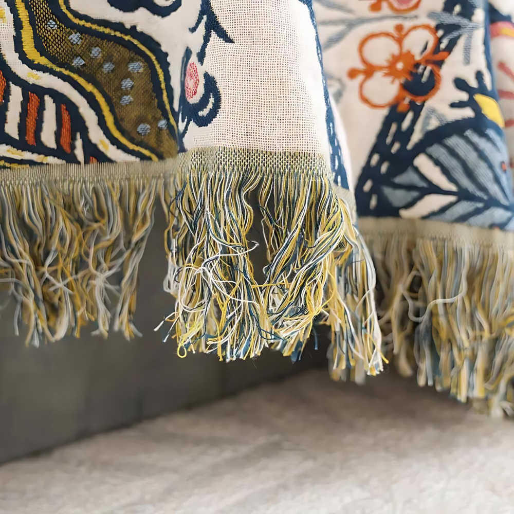 White floral blanket with colourful botanical print and fringed edge