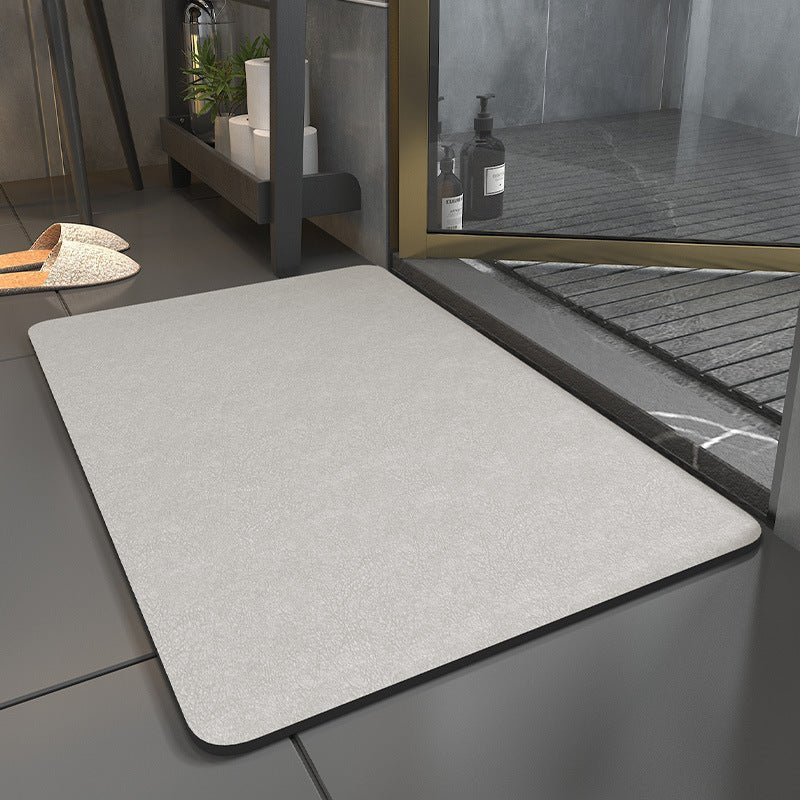Rectangular bathroom mat with rounded corners and dark edging