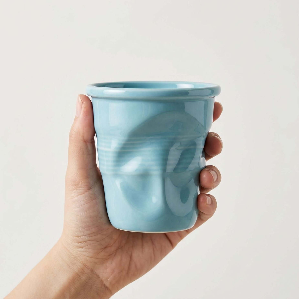 Textured ceramic mug with rounded rim and ribbed body