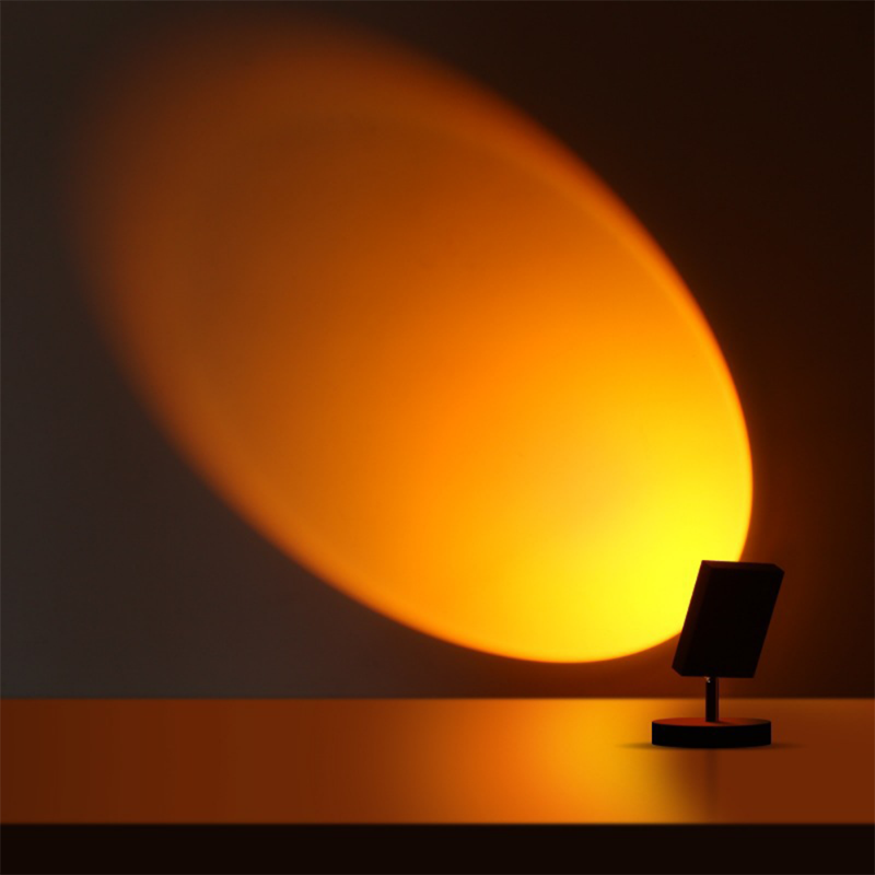 Circular glowing LED table lamp with dark stand and round base
