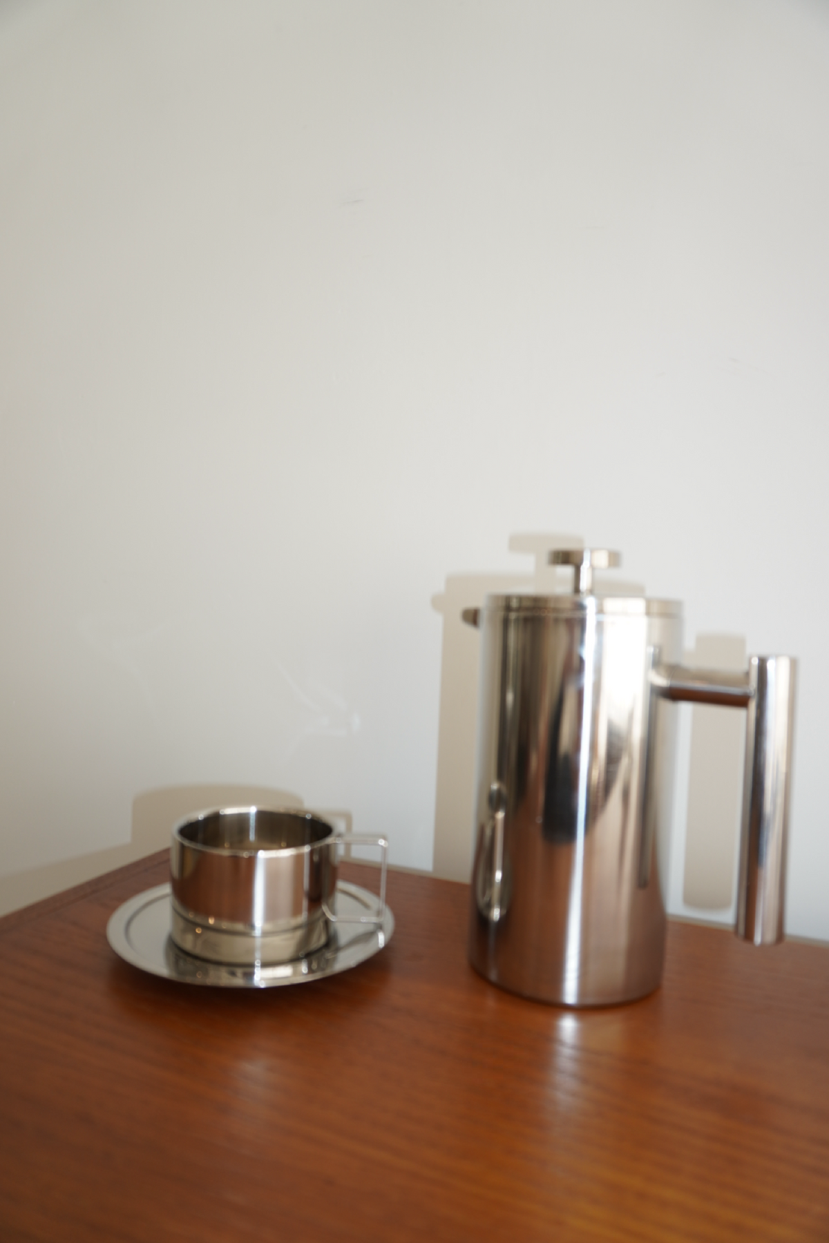 Silver handled coffee mug with matching round saucer