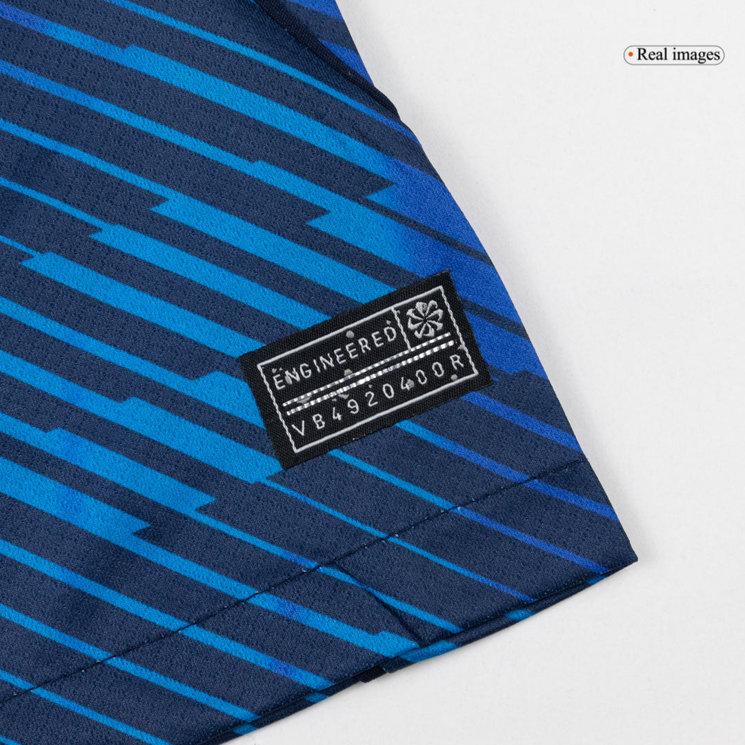 Blue short-sleeve football shirt with geometric pattern and white collar