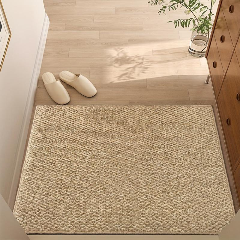 Textured beige rectangular non-slip door mat in an indoor entrance