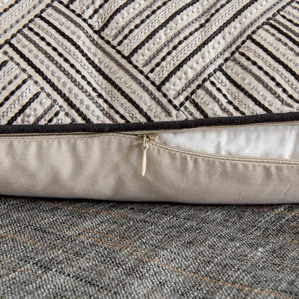Grey textured jacquard comforter set arranged with geometric decorative pillows