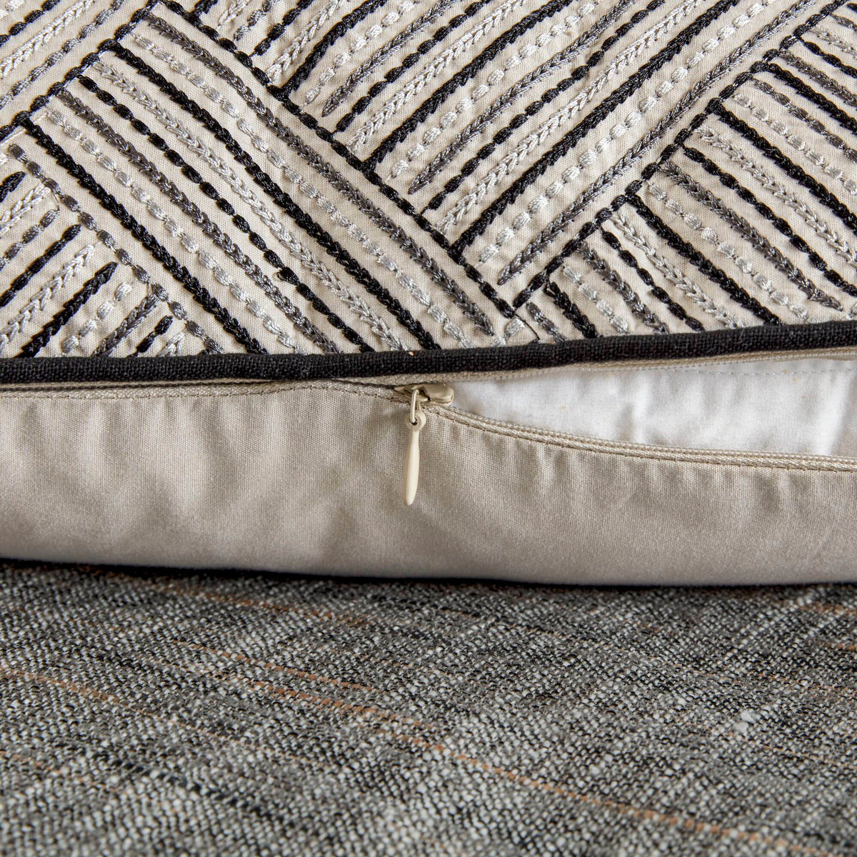 Grey textured jacquard comforter set arranged with geometric decorative pillows