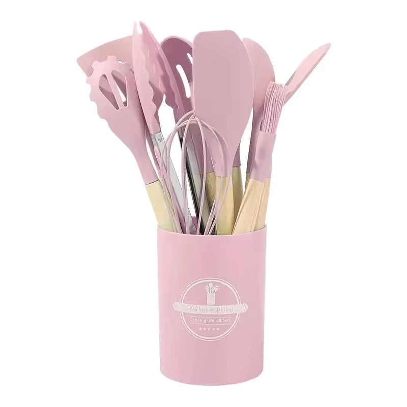 Silicone kitchen utensil set with wood-effect handles in a storage holder