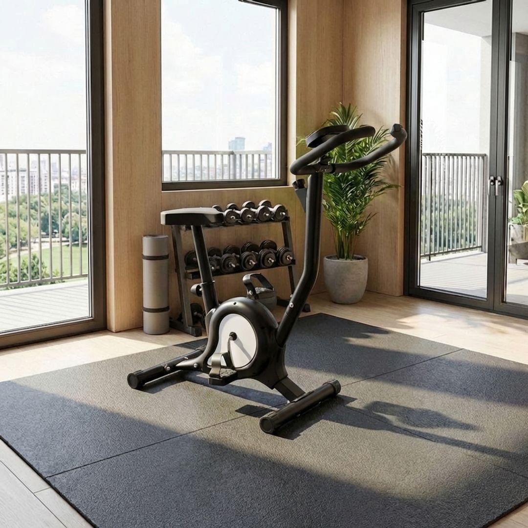 Black stationary exercise bike with adjustable seat, handlebars and pedal straps