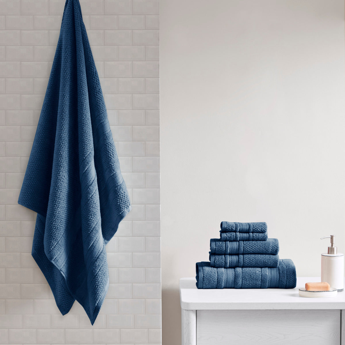 Six-piece textured bath towel set with decorative border detailing