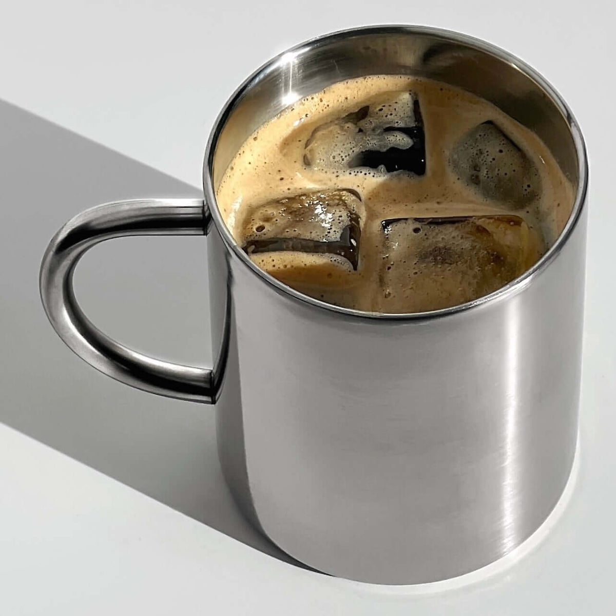 Glossy silver double-layer stainless steel cup with curved handle