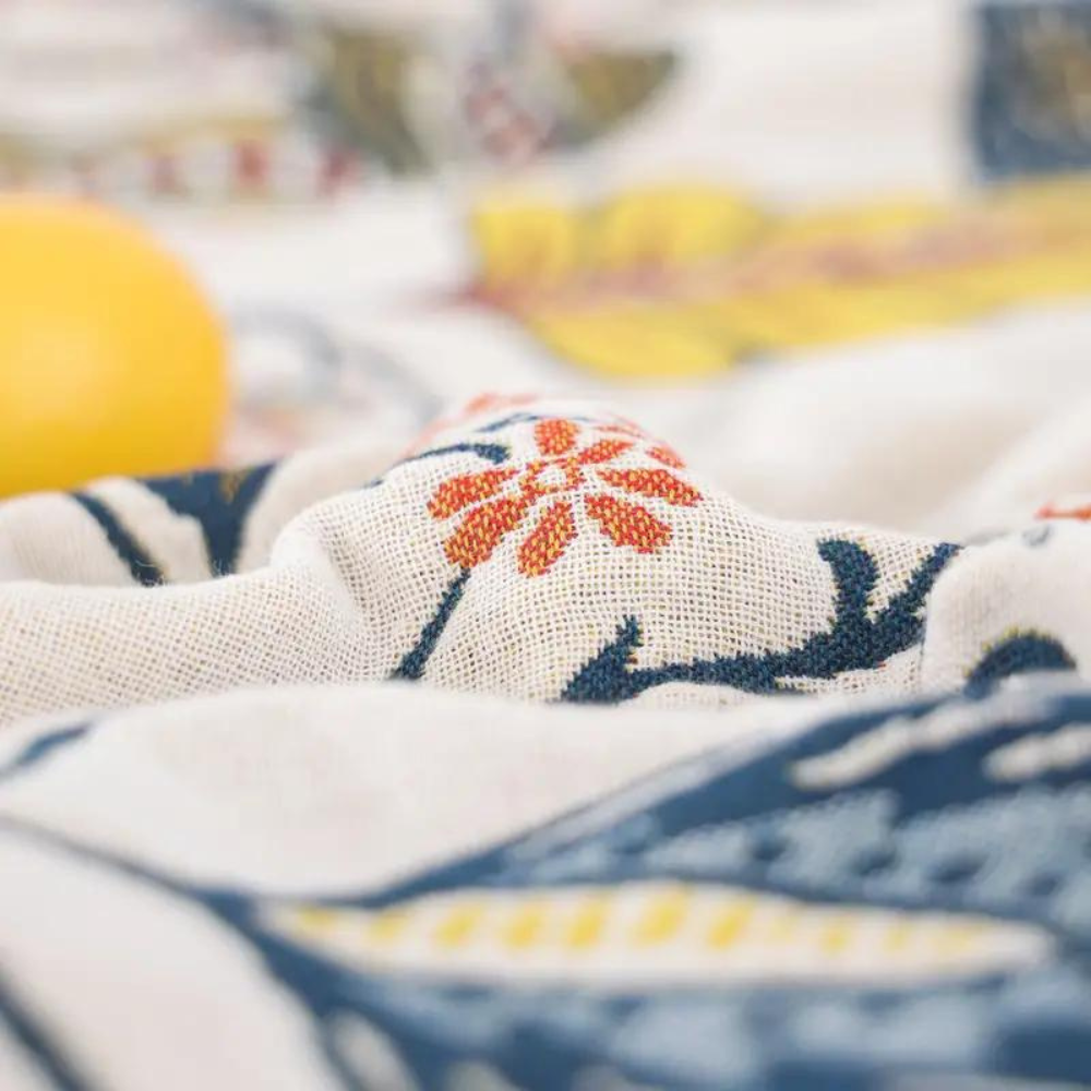 White floral blanket with colourful botanical print and fringed edge