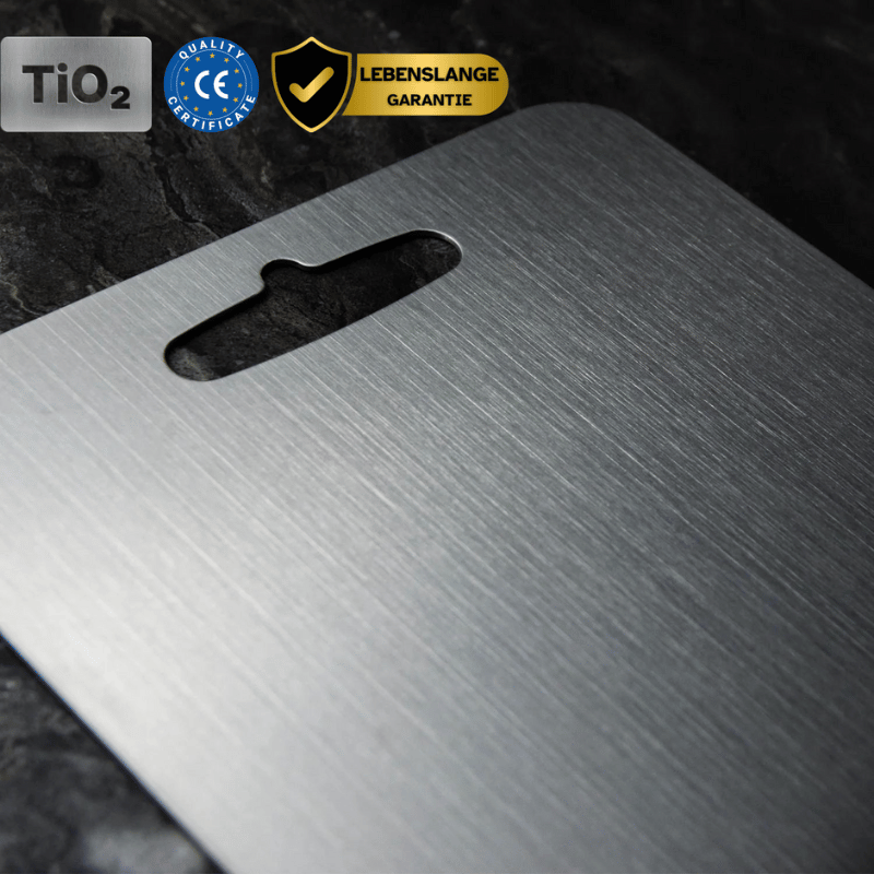 Three grey rectangular chopping boards with rounded corners and hanging holes