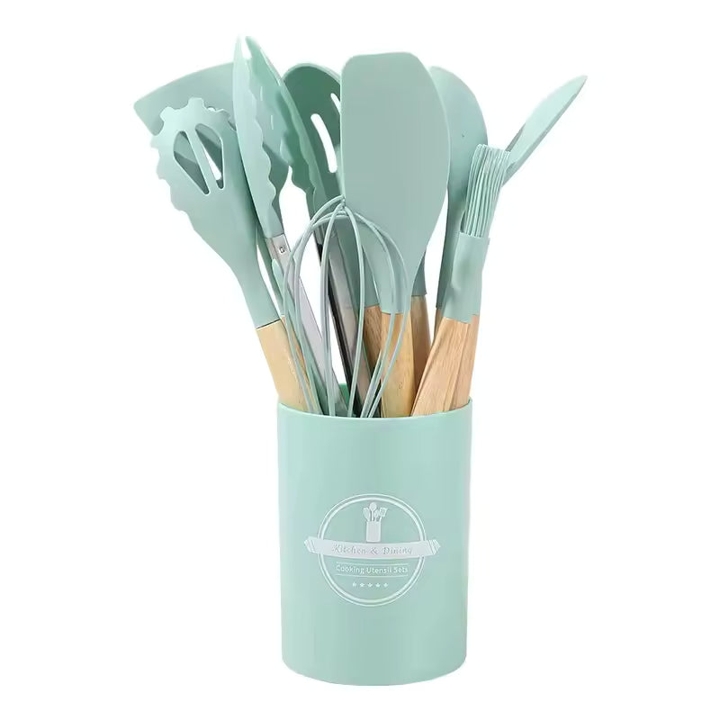 Silicone kitchen utensil set with wood-effect handles in a storage holder