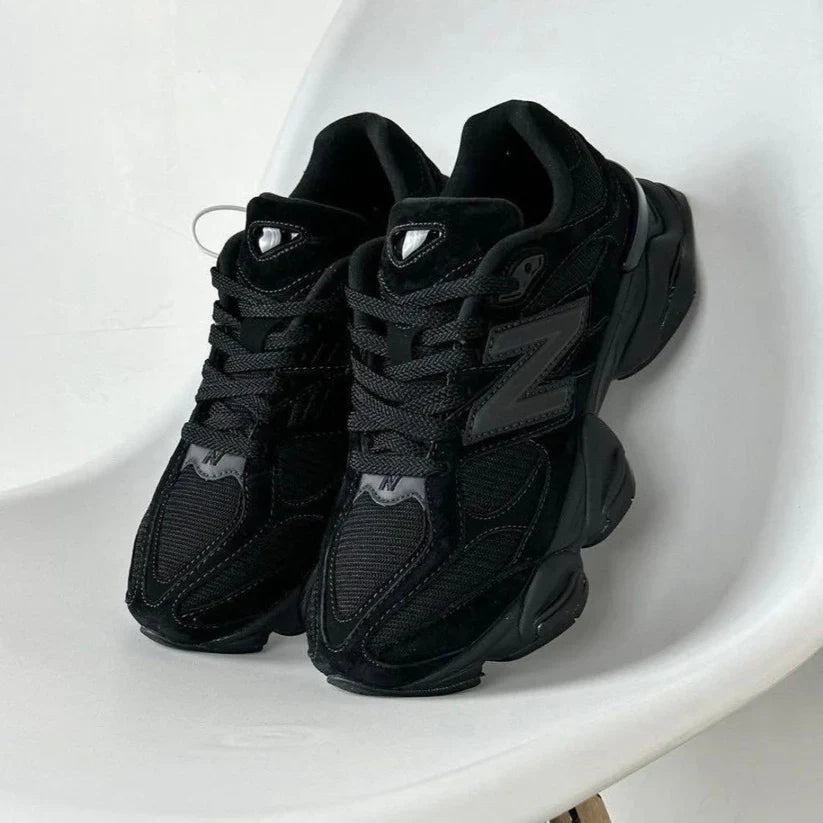 Black low top lace-up trainers with mesh panels and chunky layered soles