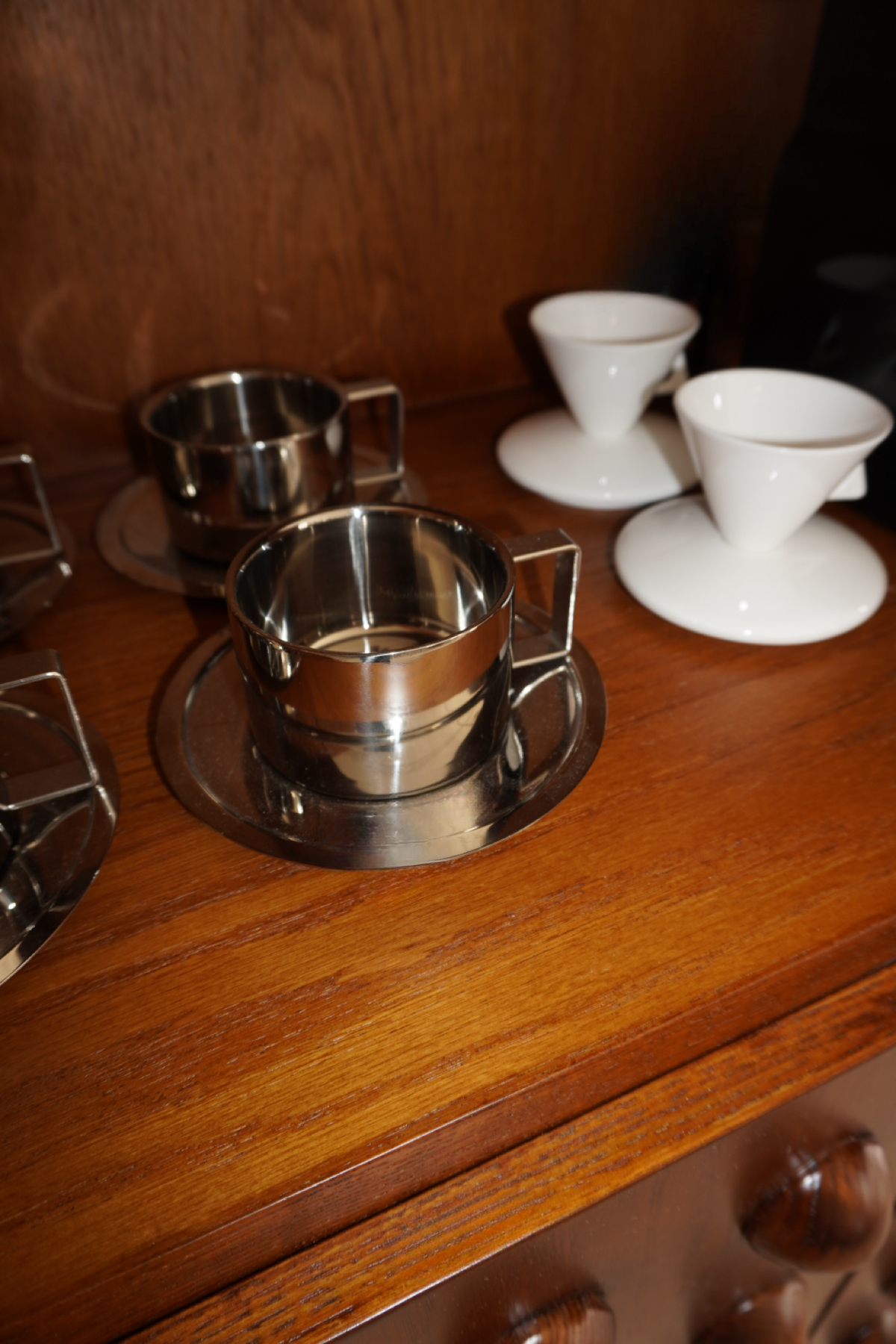 Silver handled coffee mug with matching round saucer