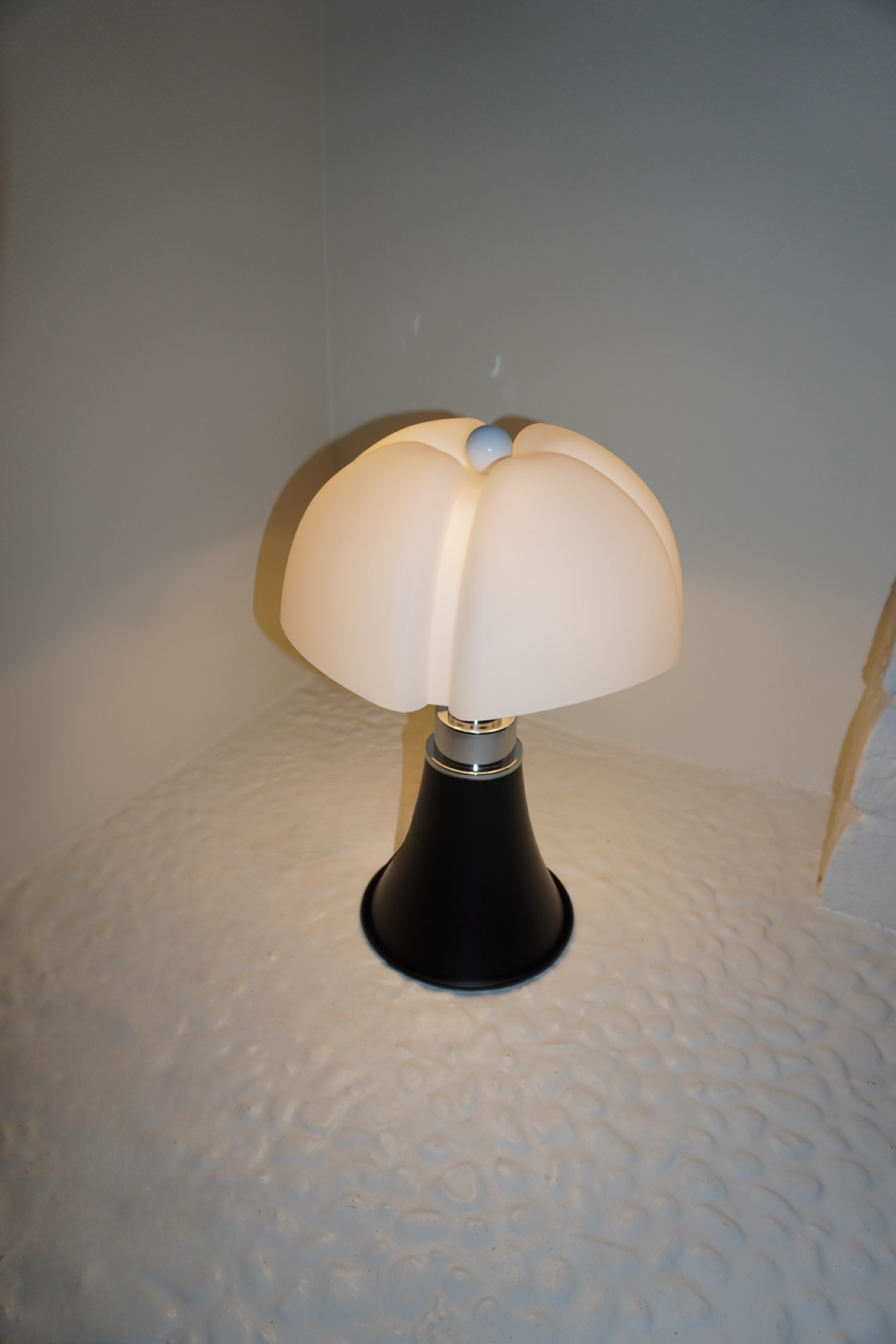 Black table lamp with sculpted soft white petal shade