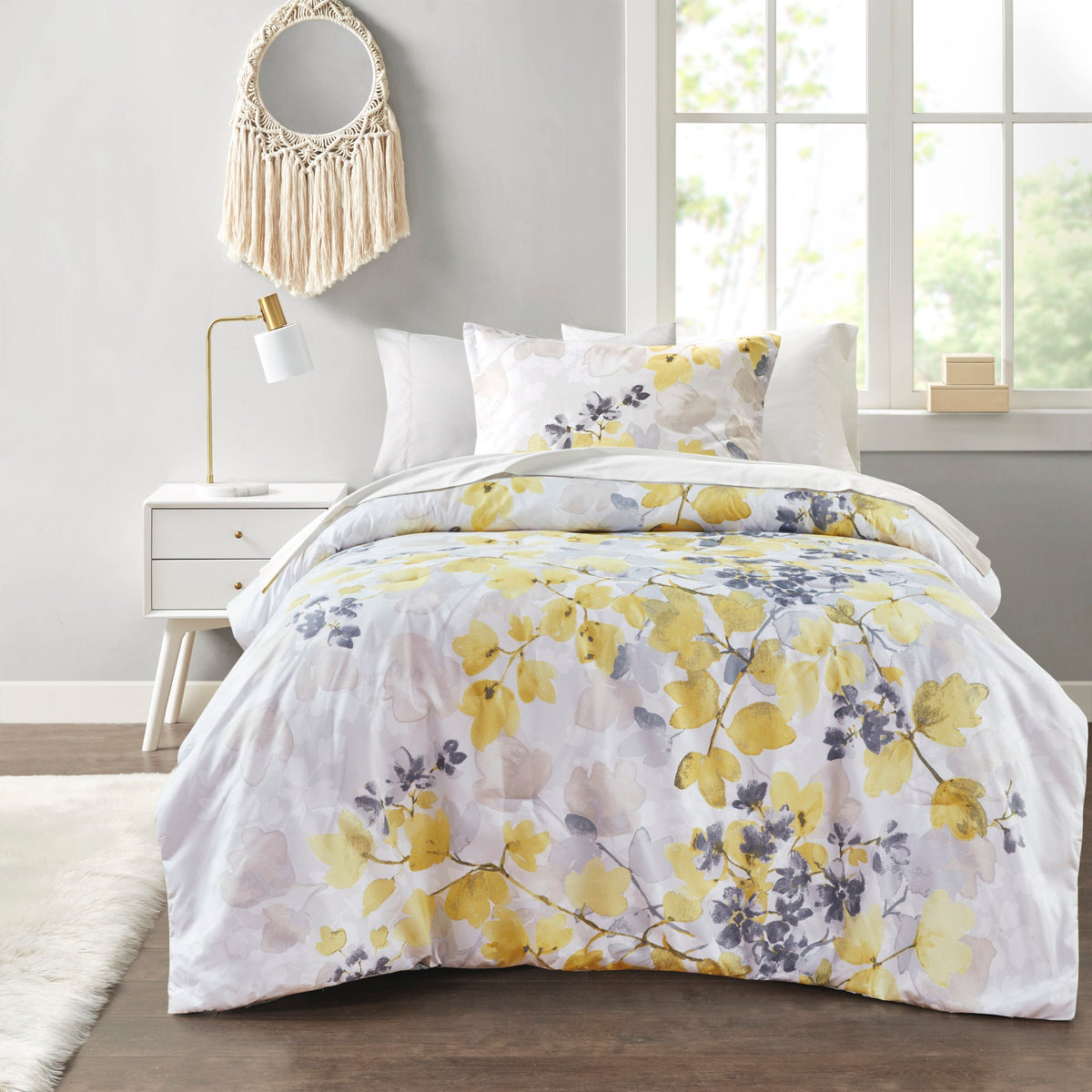 Floral comforter set with coordinating sheets and pillowcases on a bed