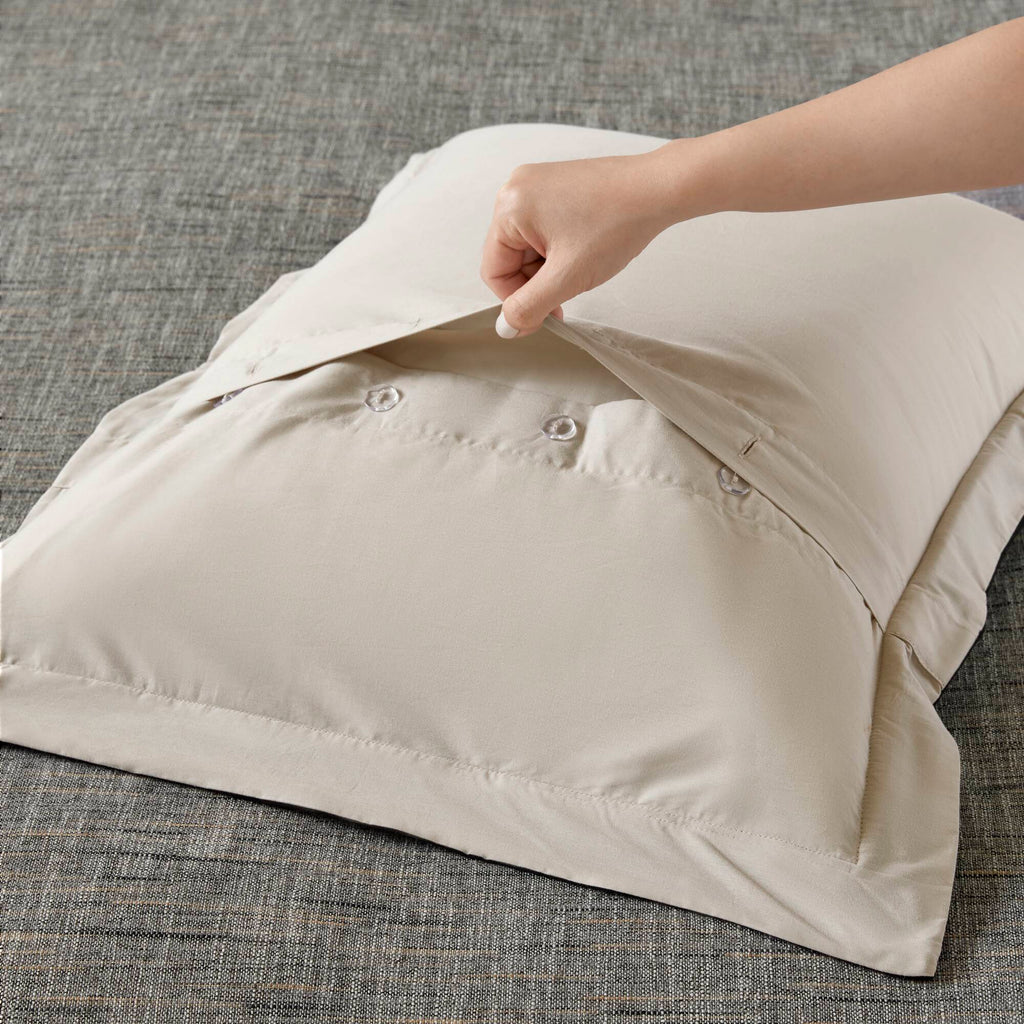 Grey textured jacquard comforter set arranged with geometric decorative pillows