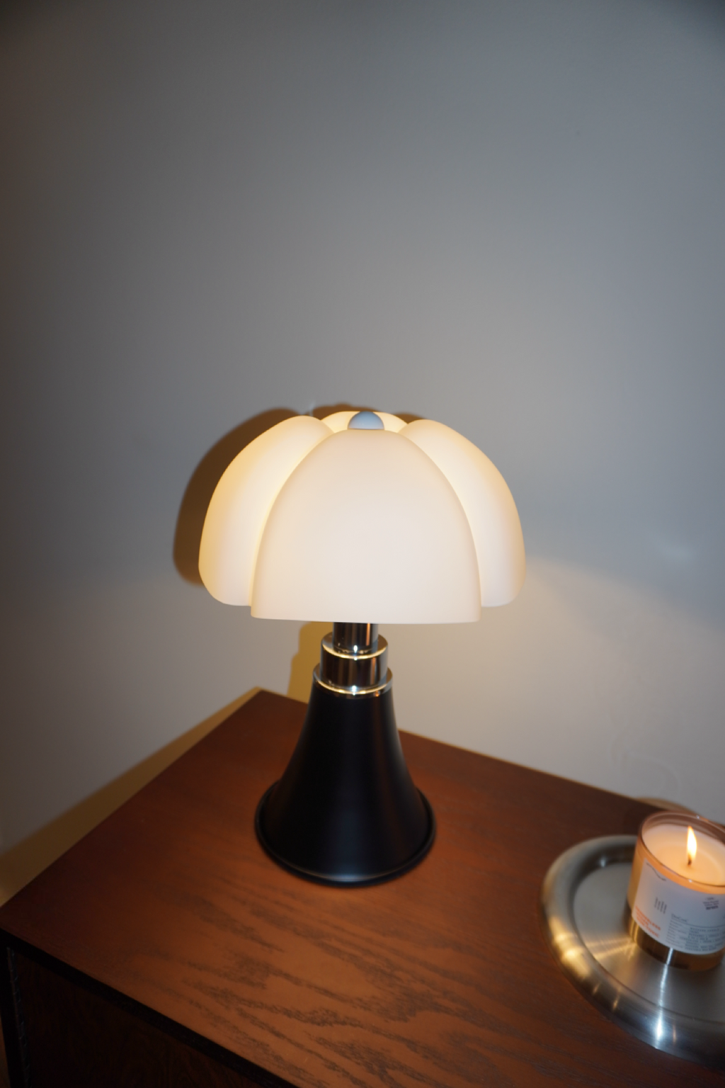 Black table lamp with sculpted soft white petal shade