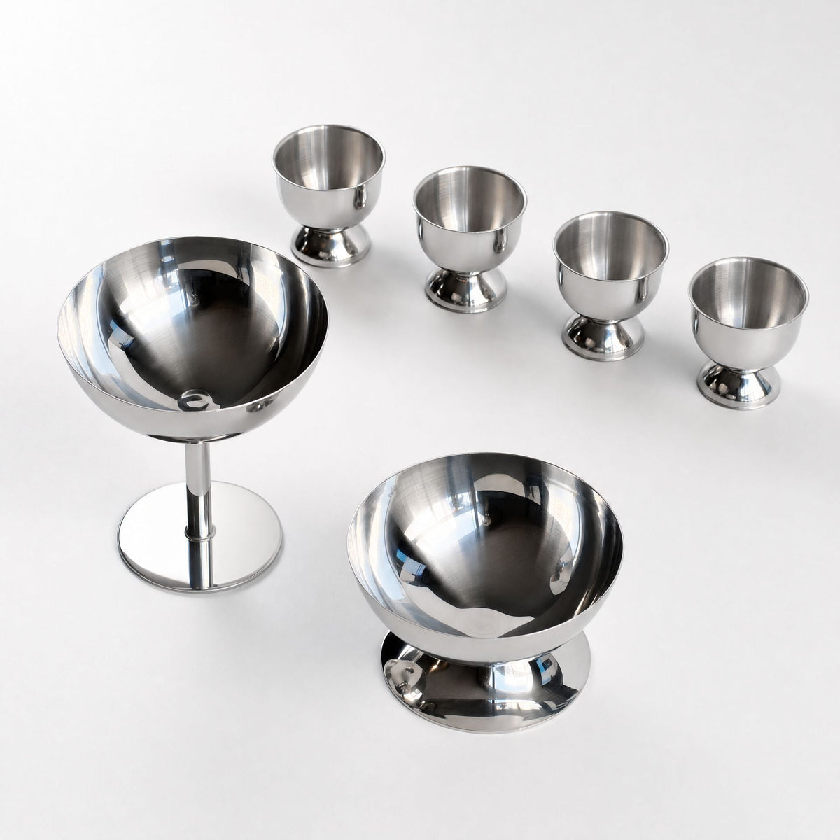 Silver stainless steel ice cream cup with a rounded bowl and pedestal base