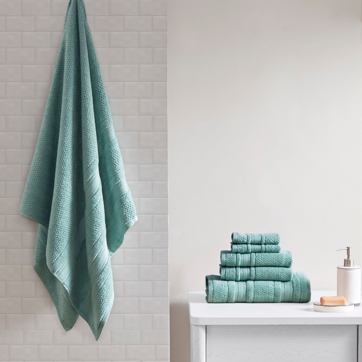 Six-piece textured bath towel set with decorative border detailing