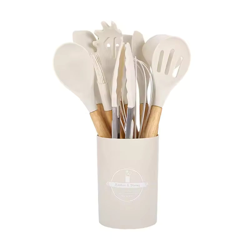 Silicone kitchen utensil set with wood-effect handles in a storage holder