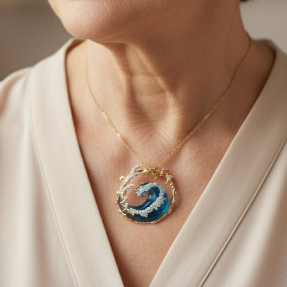 Gold-tone necklace with a circular blue wave pendant