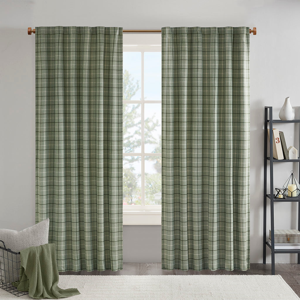 Plaid window curtain panels hanging from a curtain rod