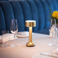 Table lamp with cylindrical shade, slim stem and round base