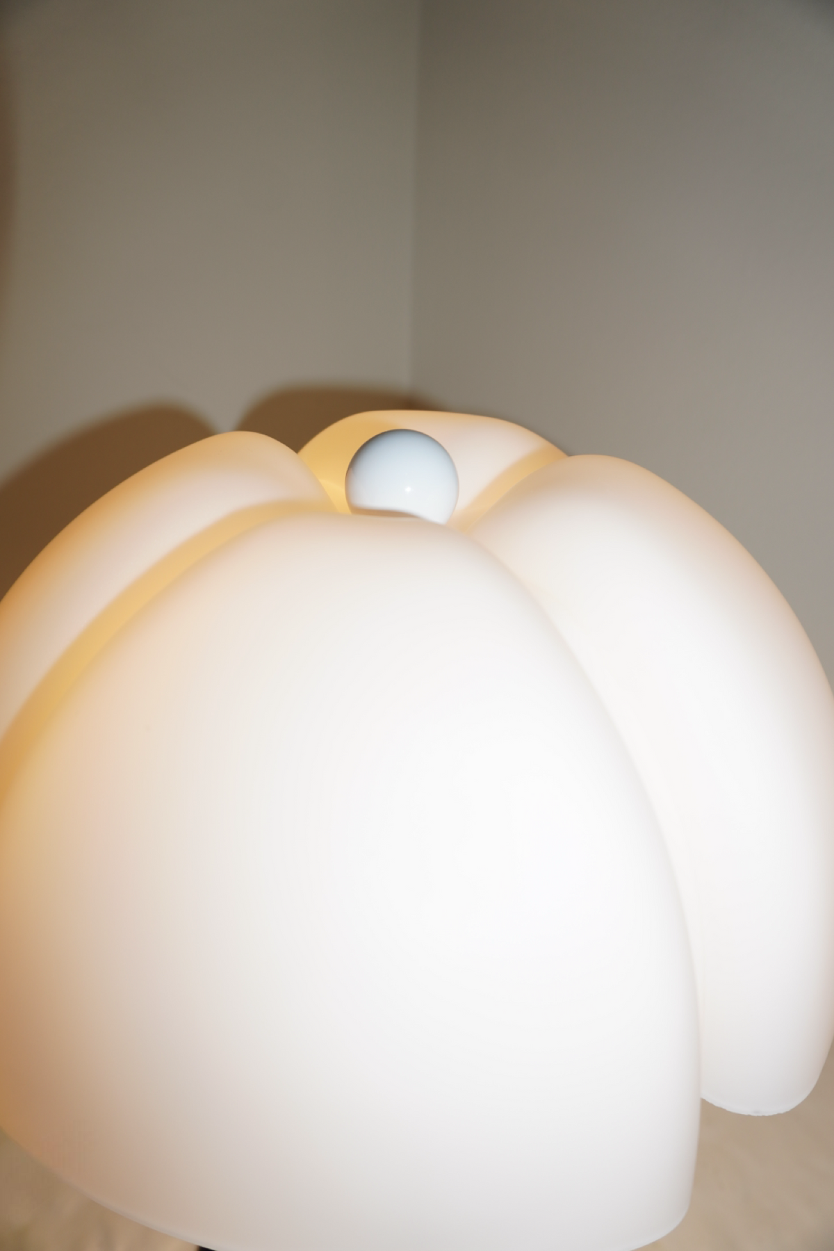 Black table lamp with sculpted soft white petal shade