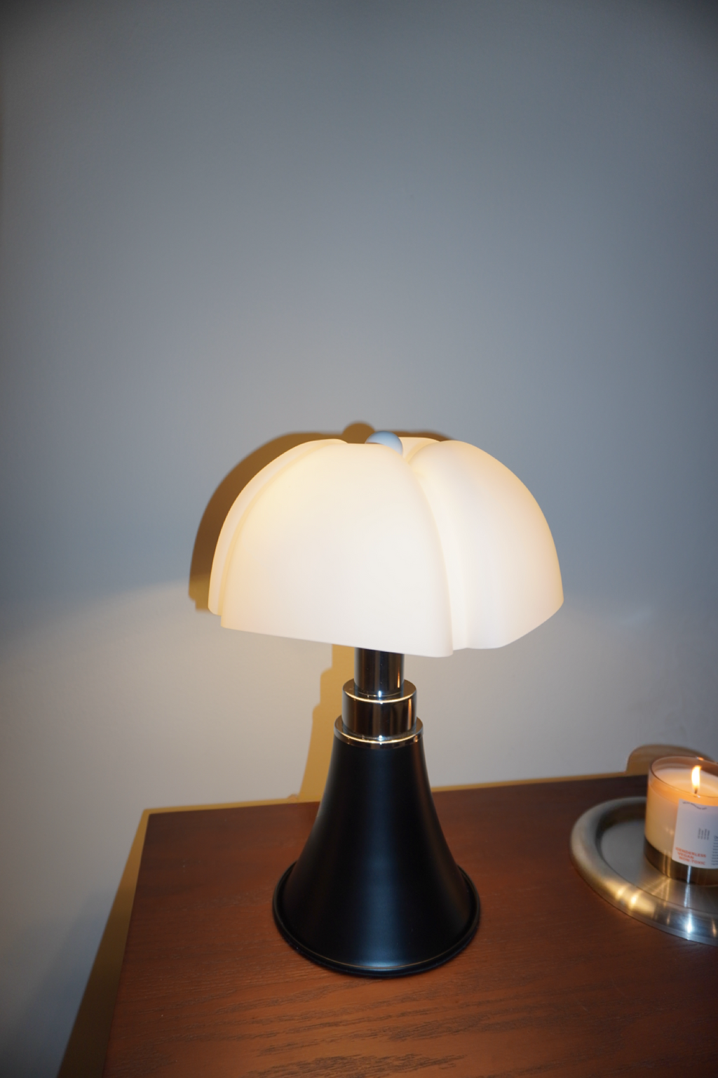 Black table lamp with sculpted soft white petal shade