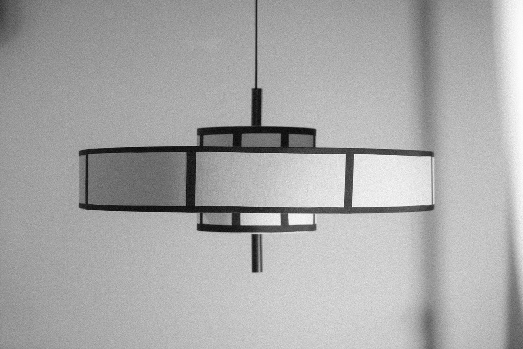 Black frame pendant light with cream drum shade