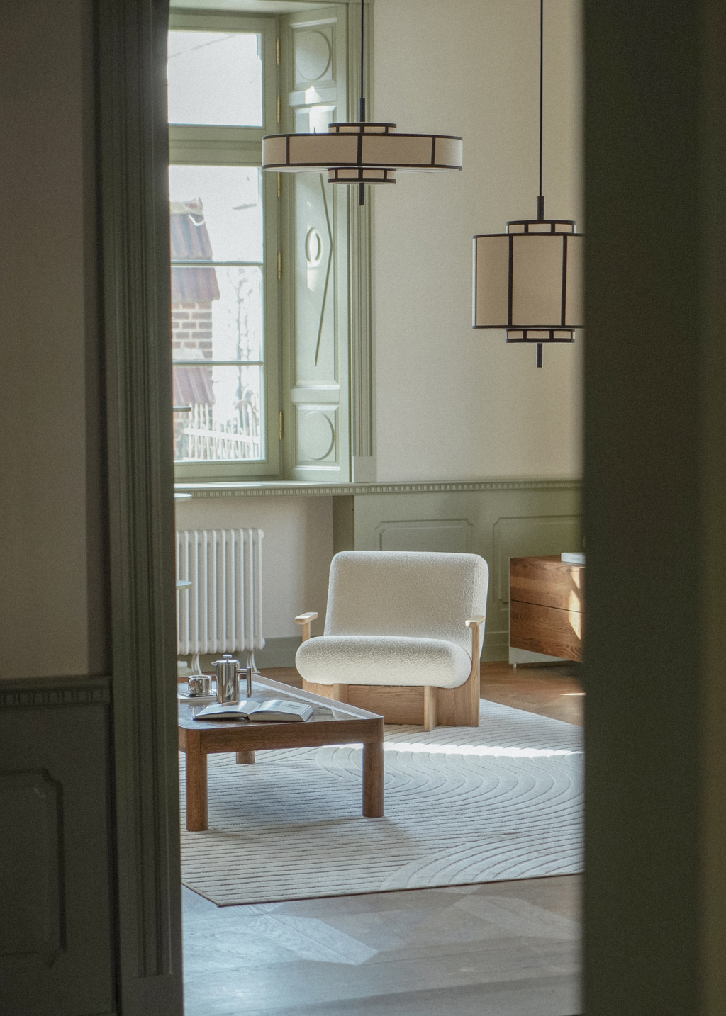 Black frame pendant light with cream drum shade