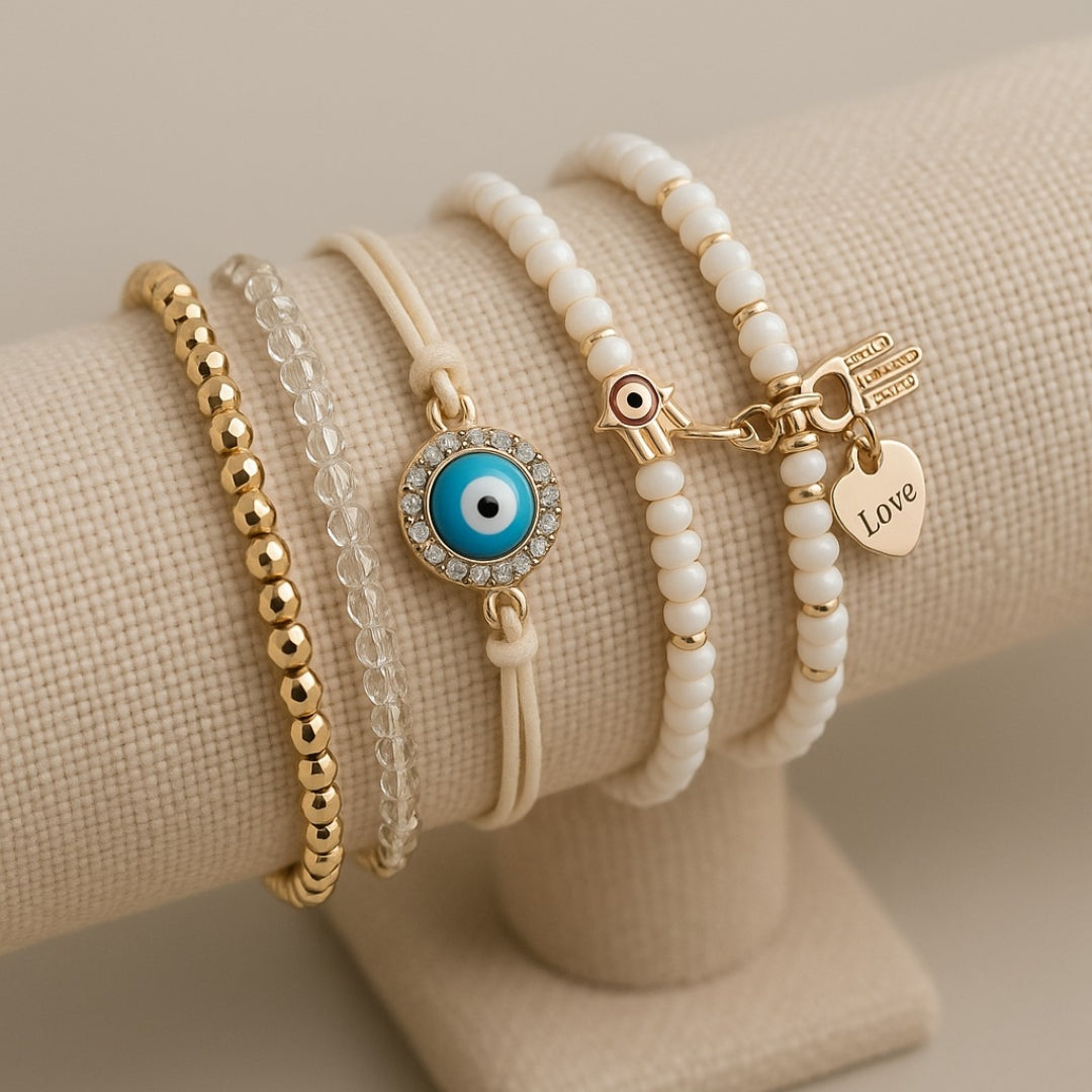 Stacked beaded charm bracelets with eye, hand and heart charms