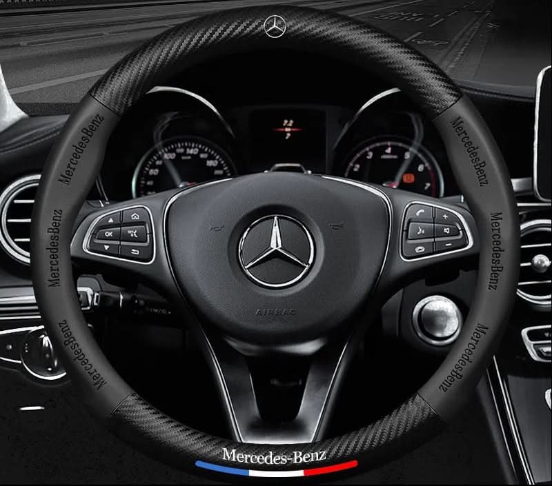 Steering wheel cover with carbon effect textured panels and accent stripe