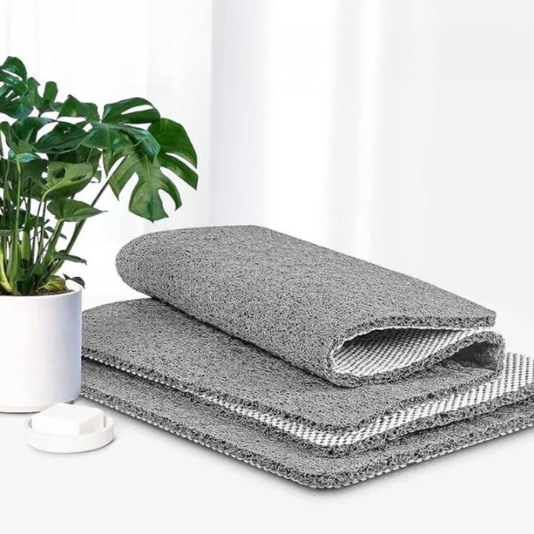 Textured rectangular non-slip shower mat beside a bathtub