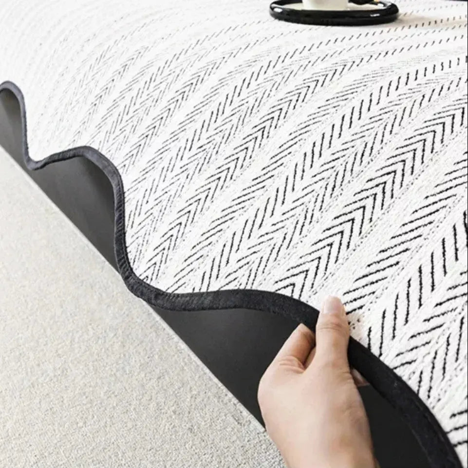 Textured herringbone sofa cover with decorative trim on a sofa