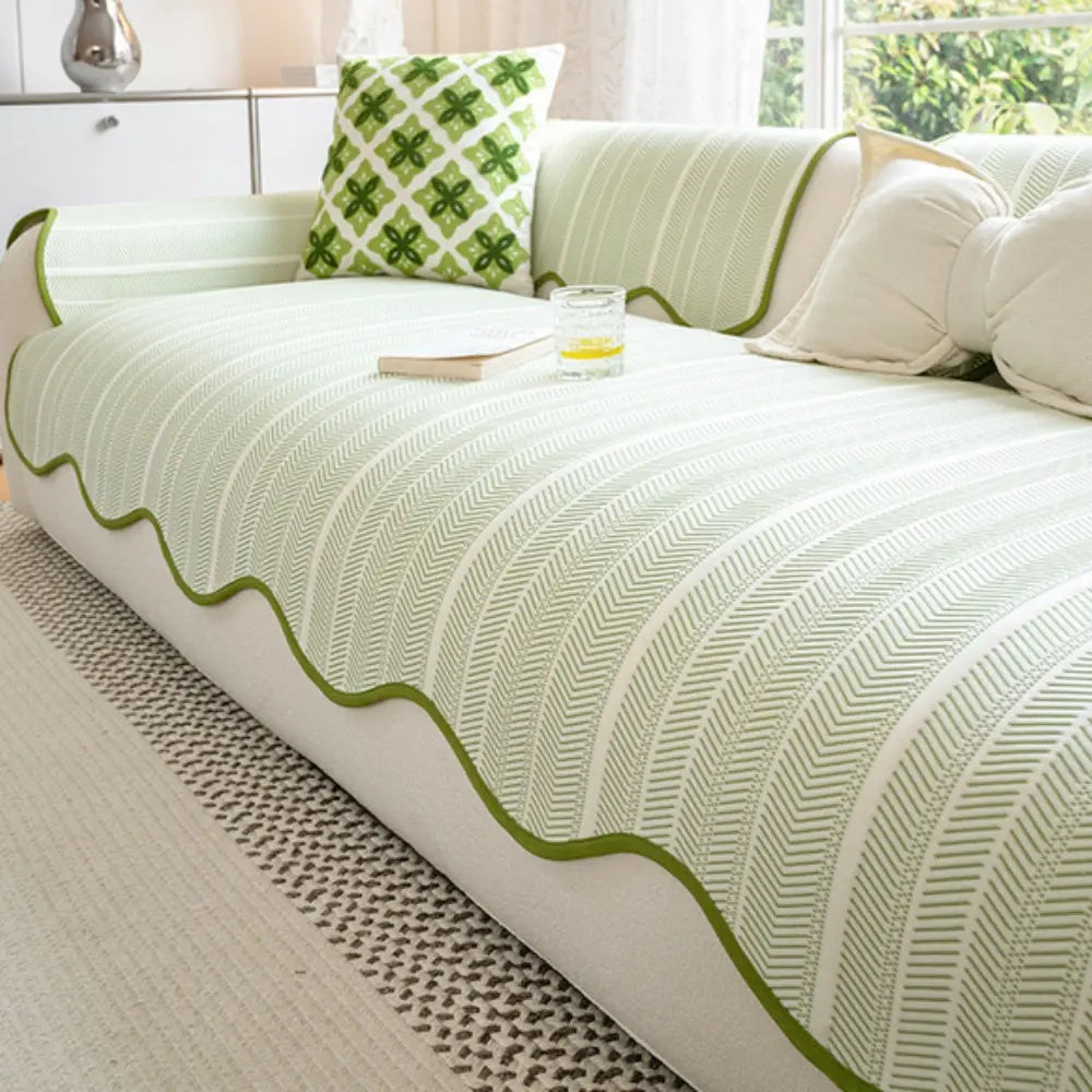 Textured herringbone sofa cover with decorative trim on a sofa