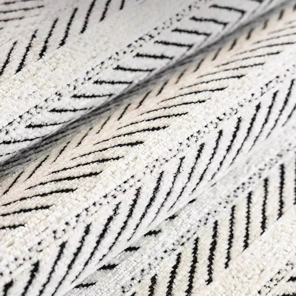 Textured herringbone sofa cover with decorative trim on a sofa