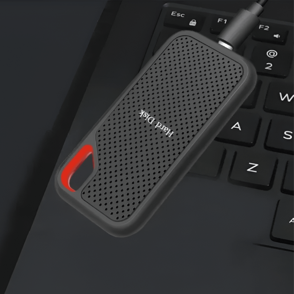 Black portable external SSD hard drive with textured case, red carry loop and USB cable