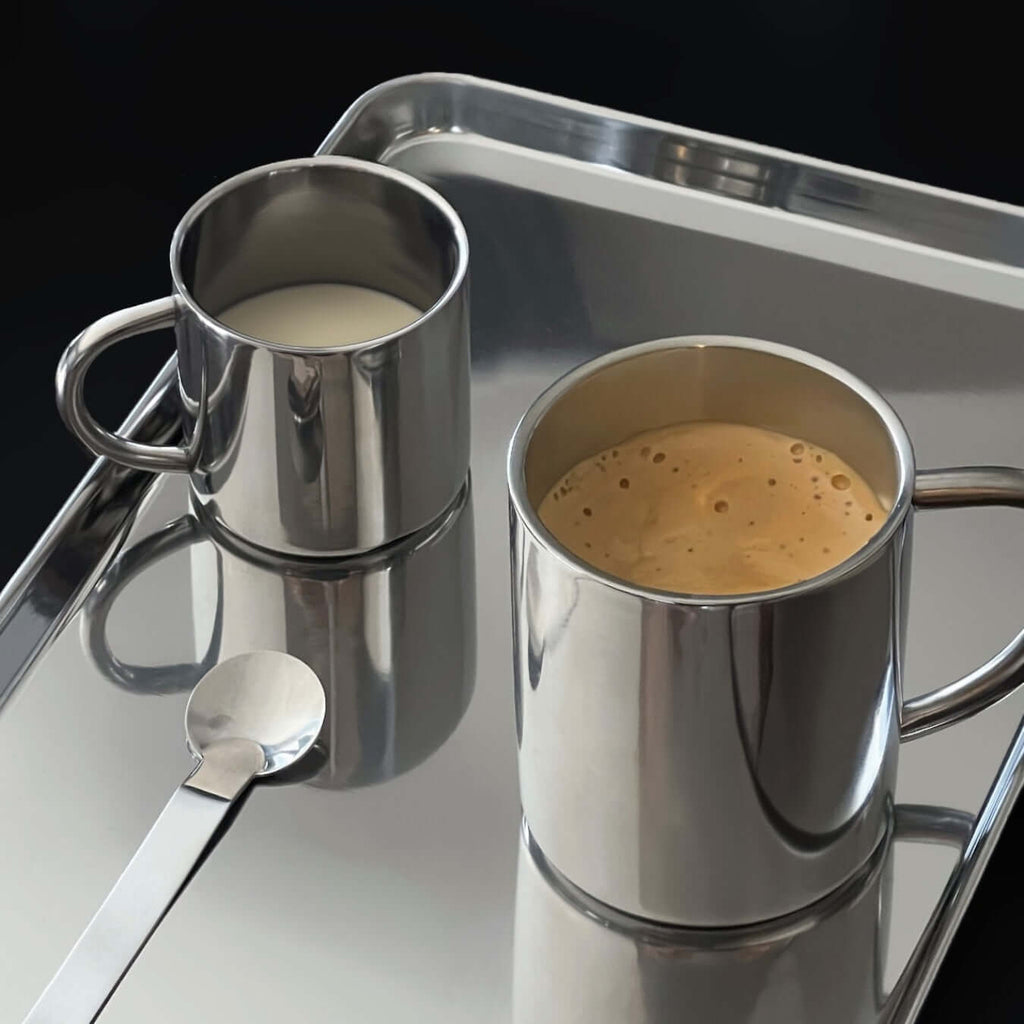 Glossy silver double-layer stainless steel cup with curved handle