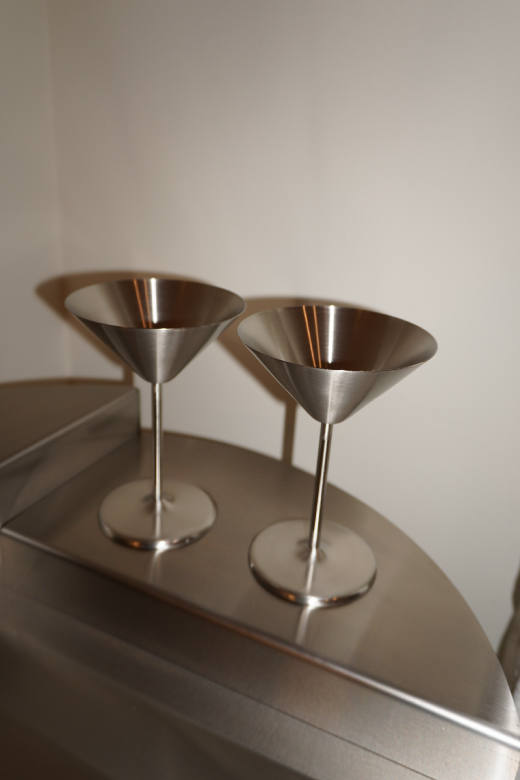 Pair of silver metallic stemmed martini glasses