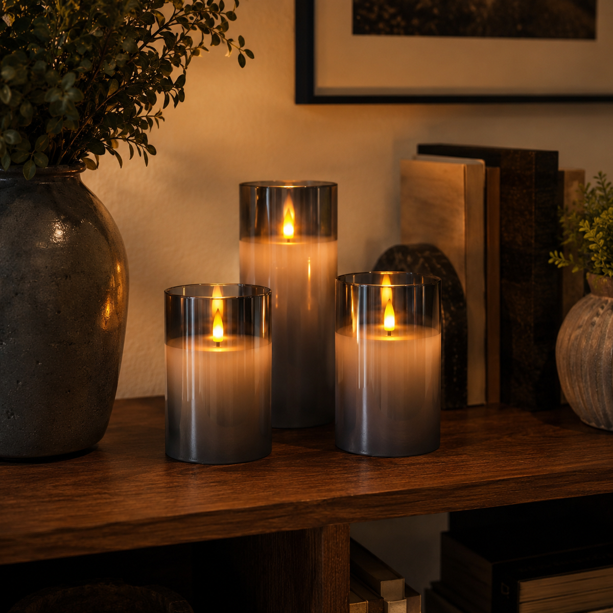 Three flameless cylindrical candle lights with flame-effect glow