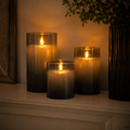 Three flameless cylindrical candle lights with flame-effect glow