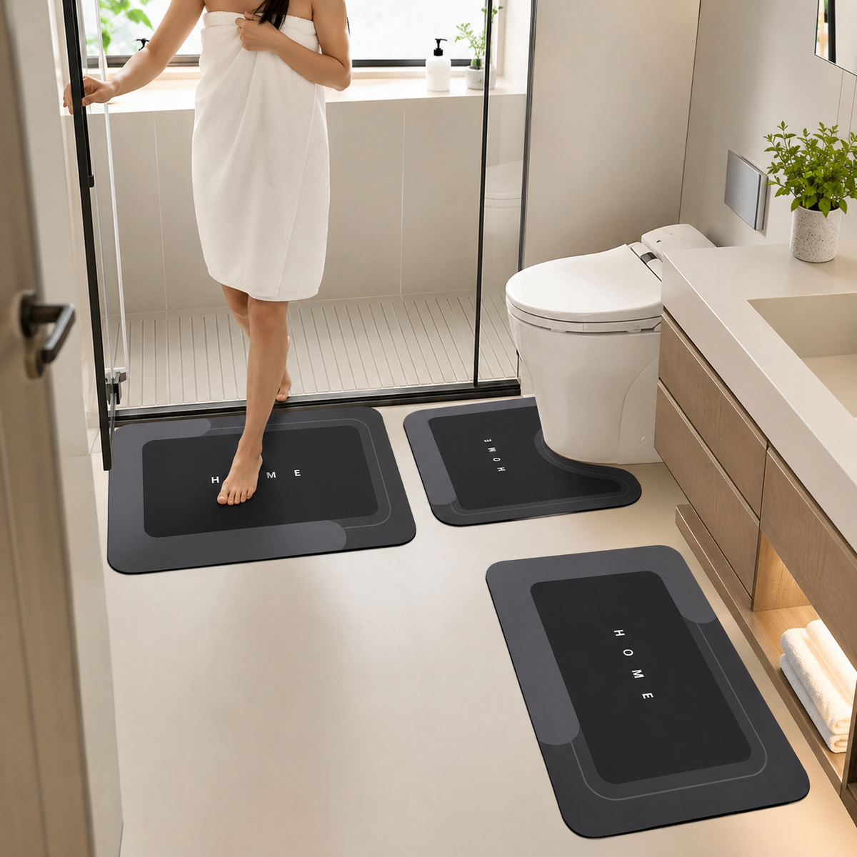Three-piece black bathroom mat set with toilet, sink and bath mats