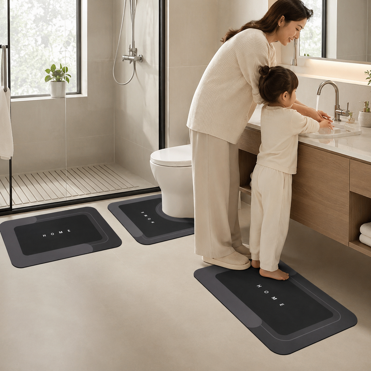 Three-piece black bathroom mat set with toilet, sink and bath mats