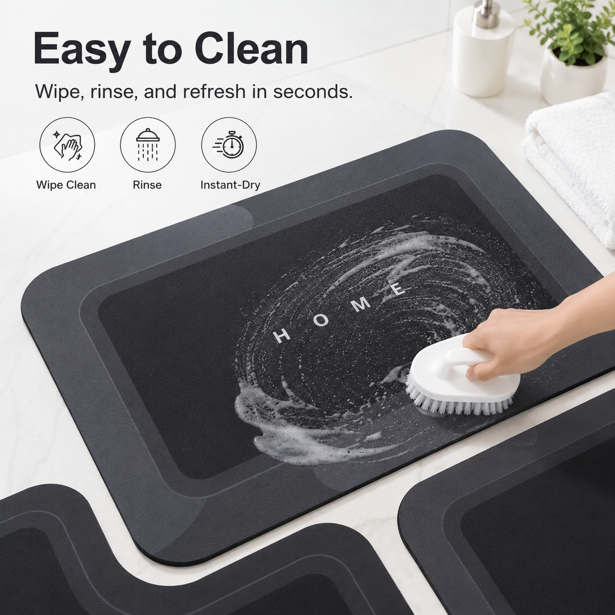 Three-piece black bathroom mat set with toilet, sink and bath mats
