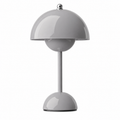Wireless table lamp with a rounded dome shade and glossy finish